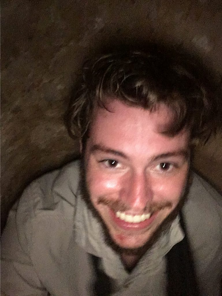 Climbing down into a hidden Cu Chi tunnel entrance